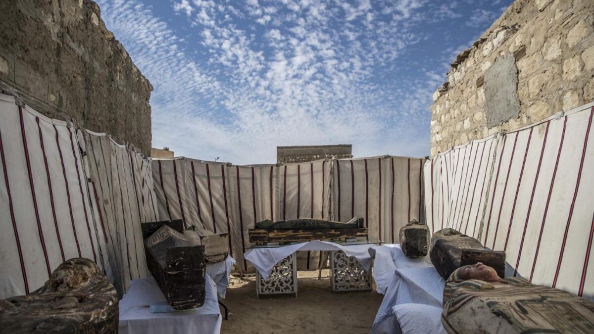 Unearthed adorned wooden sarcophagi are displayed during the official announcement of the discovery by an Egyptian archaeological mission of a new trove of treasures at Egypt's Saqqara necropolis south of Cairo, on January 17, 2021. The discovery at the necropolis which lies 30kms south of the Egyptian capital, includes the funerary temple of Queen Naert, wife of King Teti, as well as burial shafts, coffins, and mummies dating back to nearly 3000 years ago during the New Kingdom. Khaled DESOUKI / AFP