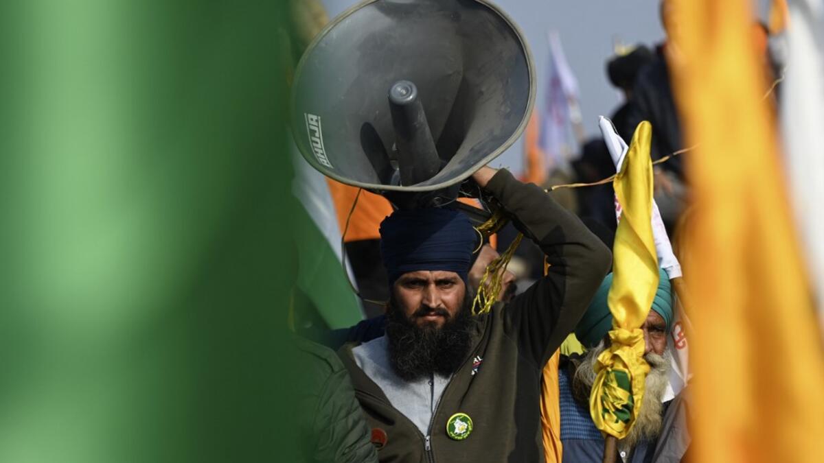 A farmer carries a loud speaker during a rally as farmers continue to demonstrate against the central government's recent agricultural reforms in New Delhi on January 26, 2021. Money SHARMA / AFP