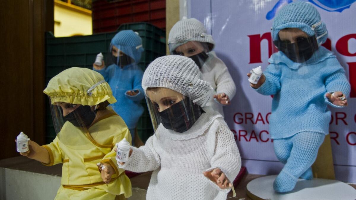View of dolls displayed for sale at the ¨Nino Uribe¨ traditional Mexican store in Mexico City on January 27, 2021. ¨Nino Uribe¨ sells representations of the Baby Jesus called Baby COVID to raise awareness on the preventive measures to take amid the COVID-19 coronavirus pandemic. CLAUDIO CRUZ / AFP