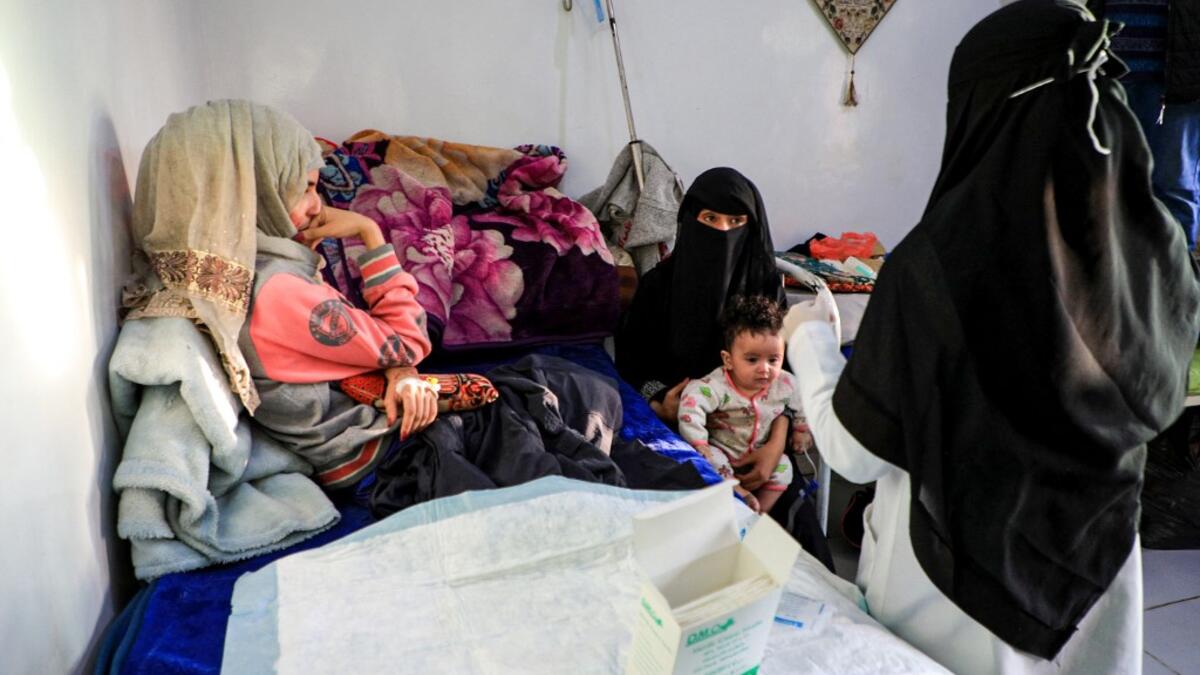Al-Anoud Hussain Sheryan (L), a 19-year-old girl disfigured in an acid attack by her abusive husband, sits at a hospital where she is undergoing treatment in Yemen's capital Sanaa on January 28, 2021. Married at the age of 12, rejected at 16, and then disfigured in an acid attack, Sheryan's fate is a shocking illustration of abuse in a society beset by war and poverty. Now aged 19, the young Yemeni woman agreed to relate her ordeal at the hands of her abusive husband -- rare testimony in a country where dom