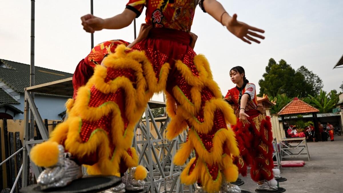 This photograph taken on January 20, 2021 shows female dancers taking part in a practice session at the Tu Anh Duong lion and dragon dance school in Can Tho city in southern Vietnam's Mekong Delta. Manan VATSYAYANA / AFP