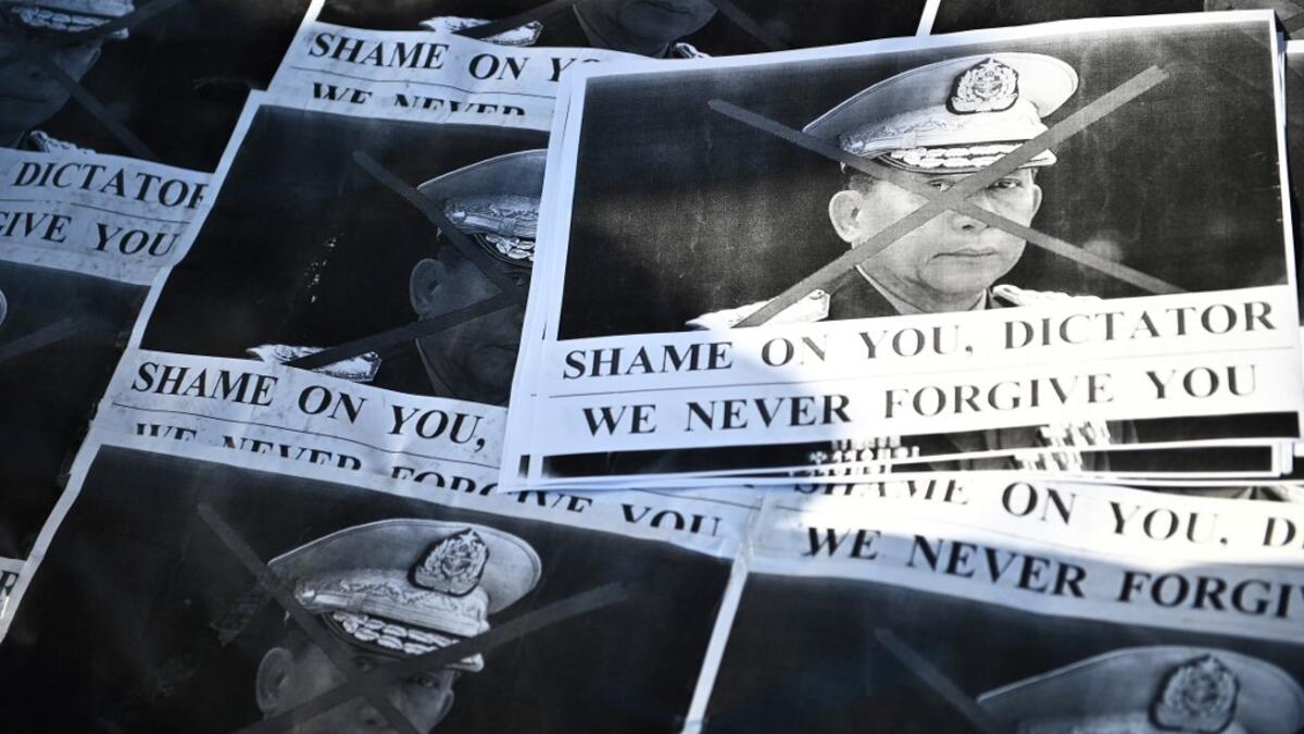 Images of Myanmar's military chief General Min Aung Hlaing are pictured as a group of Myanmar activists protest outside United Nations University building in Tokyo on February 1, 2021, following a military coup in the country after arresting civilian leader Aung San Suu Kyi and other senior officials. Philip FONG / AFP