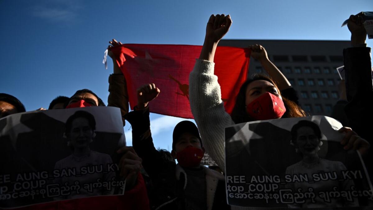 A group pf Myanmar activists chant slogans during a protest outside the United Nations university building in Tokyo on February 1, 2021 following a military coup in the country by a general after arresting civilian leader Aung San Suu Kyi and other senior officials. Philip FONG / AFP