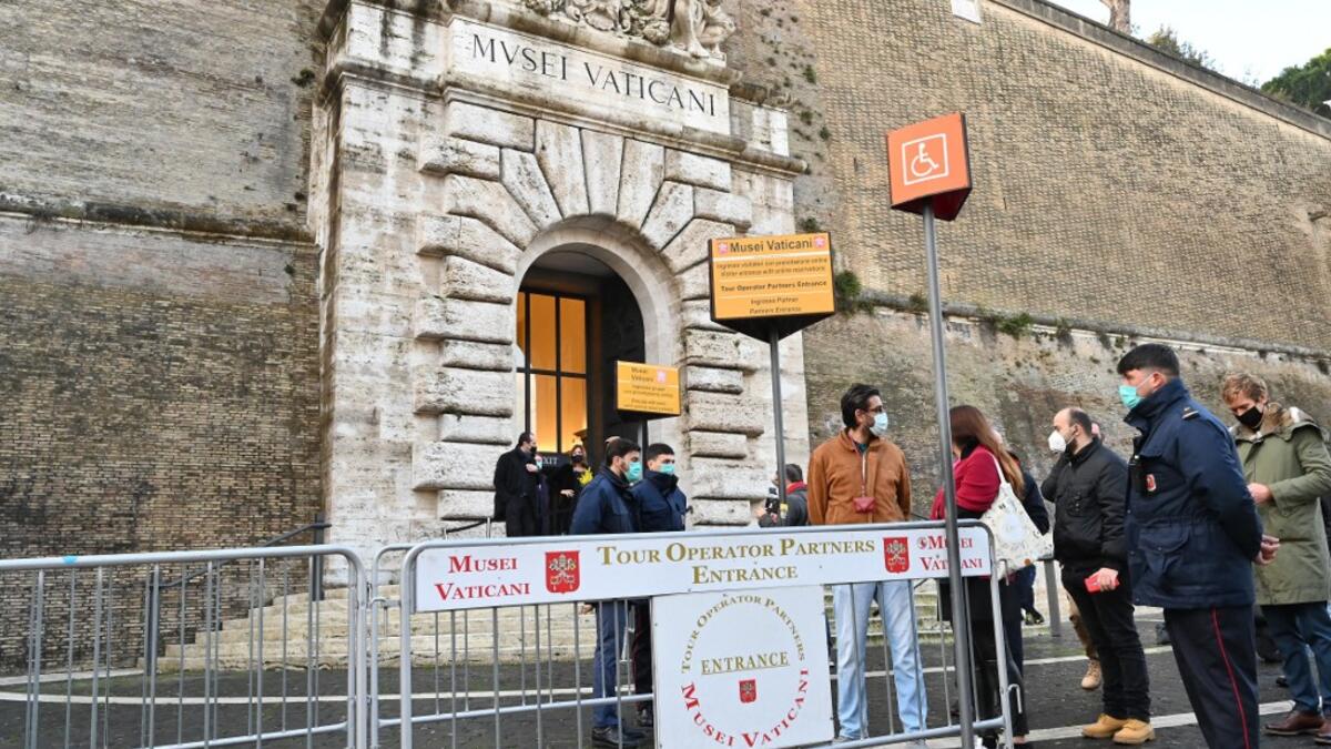 People wait at the entrance to the Vatican Museum, which reopens to the public on February 1, 2021 in Vatican City, as the city-state eases its closure aimed at curbing the spread of the COVID-19 infection, caused by the new coronavirus. Andreas SOLARO / AFP