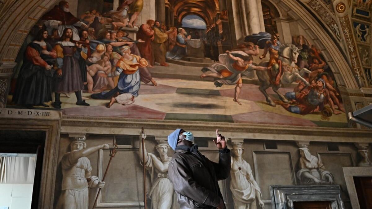 People visit one of Raphael's Rooms in the Vatican Museum, on its reopening day to the public on February 1, 2021 in Vatican City, as the city-state eases its closure aimed at curbing the spread of the COVID-19 infection, caused by the new coronavirus. Andreas SOLARO / AFP