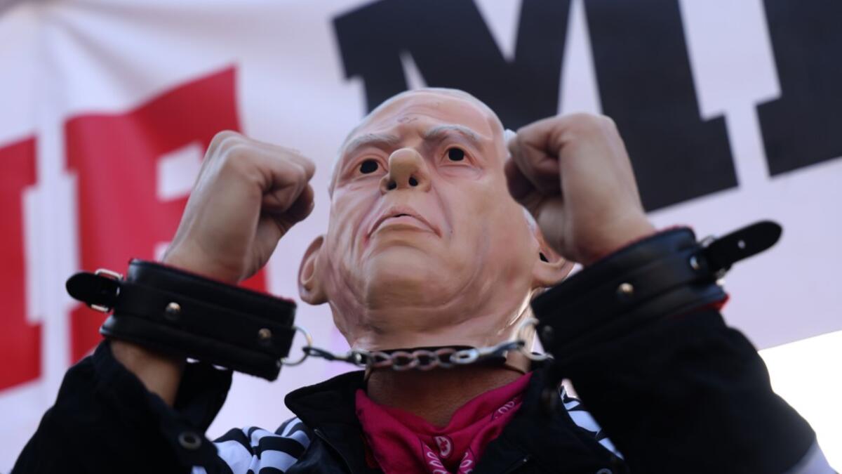 Israelis demonstrate outside the court as Prime Minister Benjamin Netanyahu's corruption trial resumes in occupied east Jerusalem, on February 8, 2021. Israel's Prime Minister Benjamin Netanyahu returns to court to formally respond to the corruption charges against him, as his trial enters an intensified phase six weeks before he faces re-election. EMMANUEL DUNAND / AFP