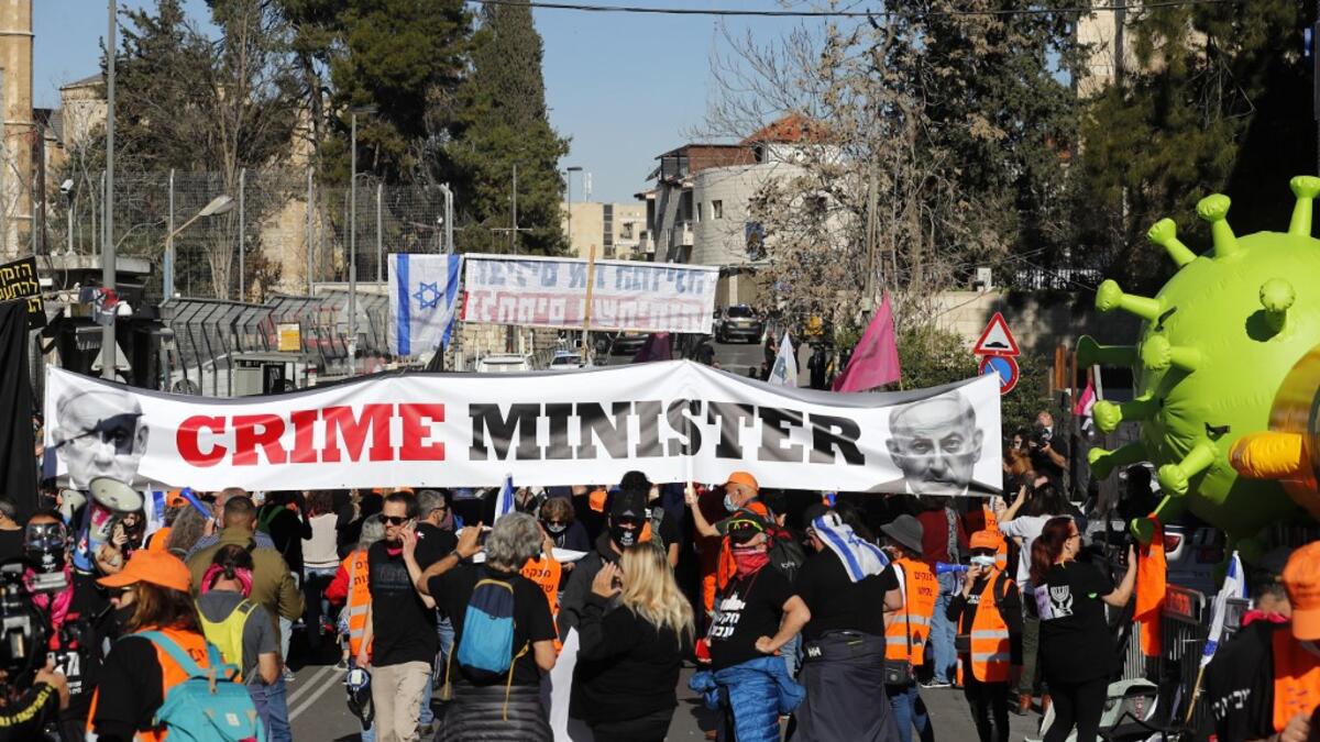 Israelis demonstrate outside the court as Prime Minister Benjamin Netanyahu's corruption trial resumes in occupied east Jerusalem, on February 8, 2021. Israel's Prime Minister Benjamin Netanyahu returns to court to formally respond to the corruption charges against him, as his trial enters an intensified phase six weeks before he faces re-election. Ahmad GHARABLI / AFP