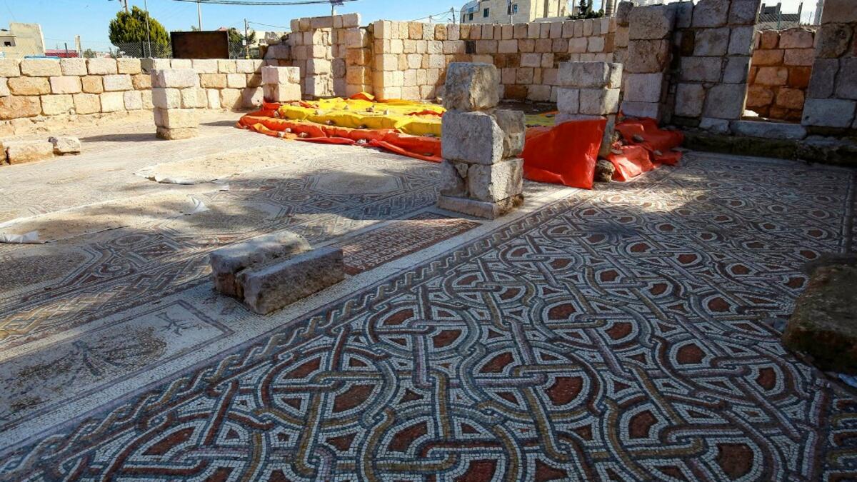 This picture shows the mosaic flooring of the Saint Mary church, built in 543 AD, the restoration of which was recently completed by workers employed by a pilot project run by the UN cultural agency UNESCO, in the small town of Rihab, some 70 kilometres north of the Jordanian capital Amman, on February 9, 2021. In the ruins of the ancient Byzantine church in Jordan, local townspeople and Syrian refugees work side by side on a project that unites preserving cultural heritage and fighting poverty.  Khalil MAZ