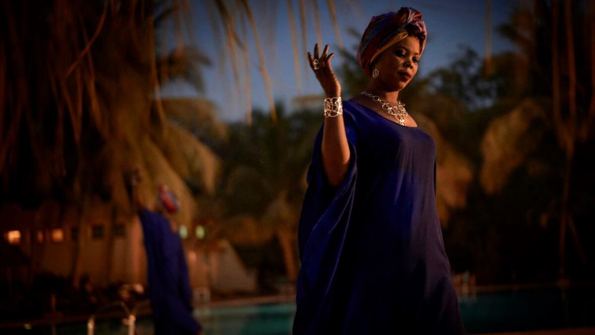 A gold miner presents creations as she takes part in a fashion show as part of the first edition of the International Gold Fair Afrik'Or, in Bamako, on February 12, 2021. The Princess of Burundi Esther Kamatari, selected 34 women among gold mines workers in southern Mali, to walk down the catwalk for a fashion show organised during the International Gold Fair. Gold represents 15% of Mali's exports and more than 20% of its GDP estimated at nearly US$20 billion by the end of 2019. MICHELE CATTANI / AFP