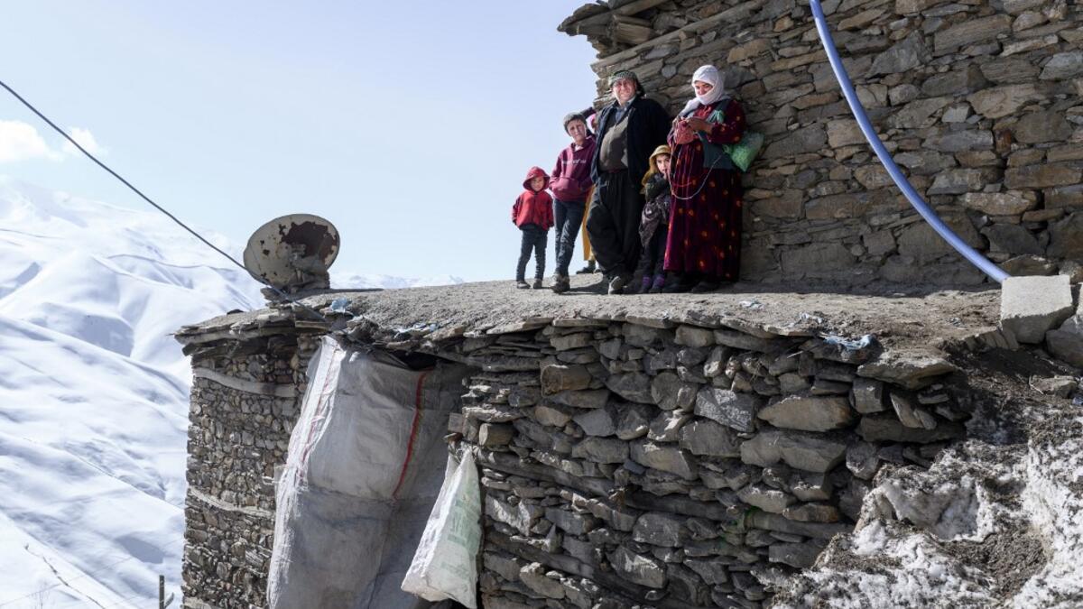 n this photograph taken on February 15, 2021, Kurdish villagers look at members of the Bahcesaray public hospital vaccination team as they arrive at the village of Guneyyamac in eastern Turkey, as part of an expedition to vaccinate residents of 65 years old or above with Sinovac's CoronaVac Covid-19 vaccine. Turkey's population of more than 83 million is spread out across Europe and Asia and covers some seemingly impregnable terrain. The vaccination effort with China's CoronaVac jab kicked off with a bang i