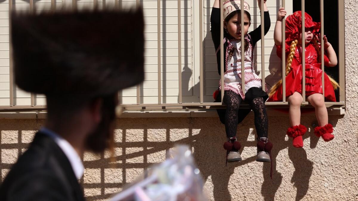 Israelis dressed in costumes in celebration of the Jewish holiday of Purim are pictured in the ultra-Orthodox neighborhood of Bnei Brak, on February 26, 2021. Israel imposed a night-time curfew for three nights from yesterday evening to curb the spread of the coronavirus during the Jewish holiday of Purim, the government said. The curfew, from 8:30 pm to 5:00 am daily (1830 GMT to 0300 GMT), will be in force from Thursday night until Sunday morning, a joint statement from the prime minister's office and the