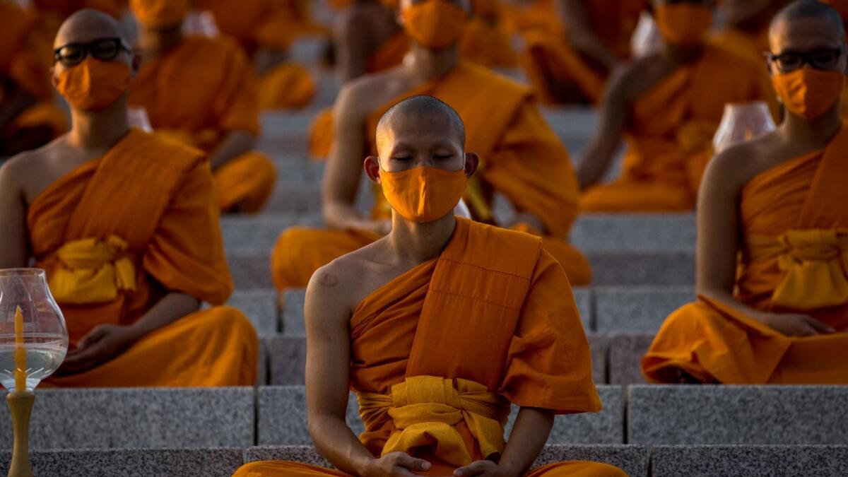 Buddhist monks attend the Makha Bucha celebrations at Wat Dhammakaya, north of Bangkok on February 26, 2021. Jack TAYLOR / AFP