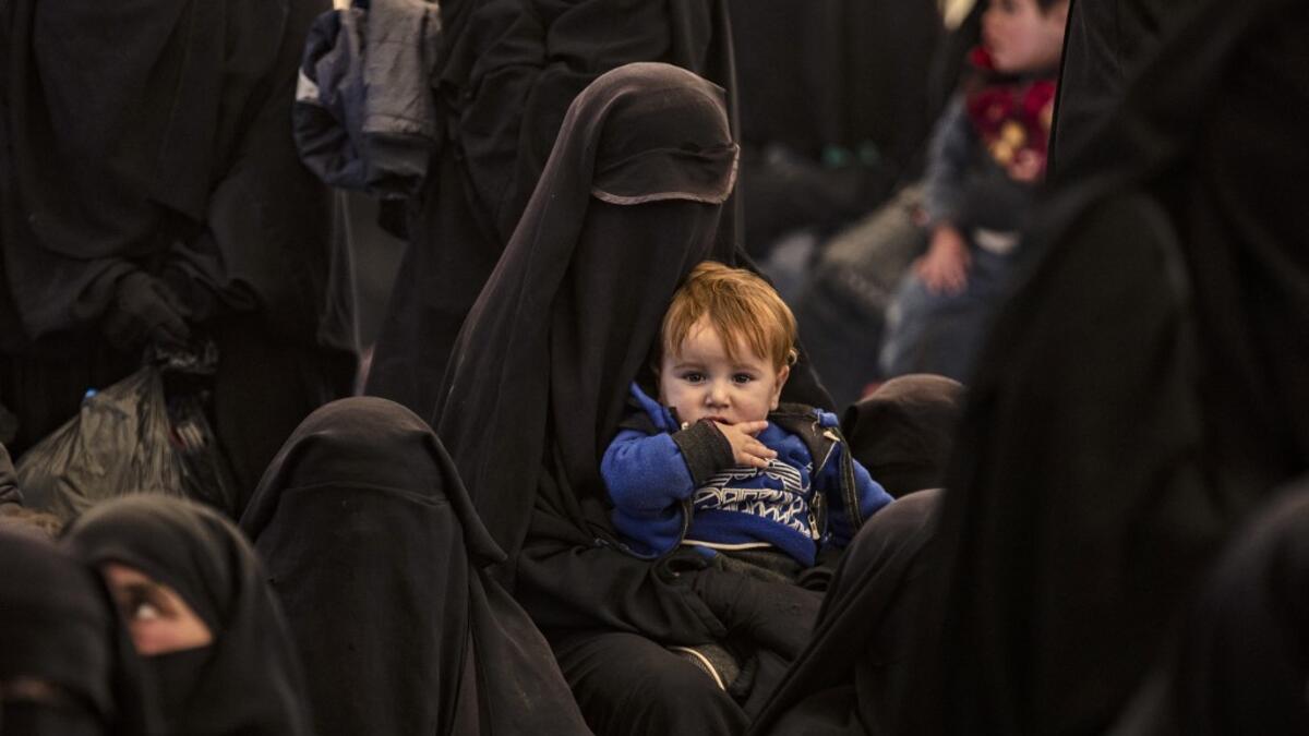 Syrians wait to leave the Kurdish-run al-Hol camp, which holds relatives of alleged Islamic State (IS) group fighters, in the Syrian northeastern al-Hasakeh governorate.