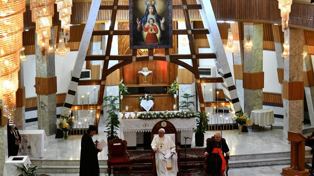 Pope Francis (C) visits Baghdad's Syriac Catholic Cathedral of Our Lady of Salvation