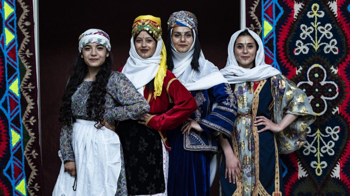 Syrian Kurdish women in traditional attire pose