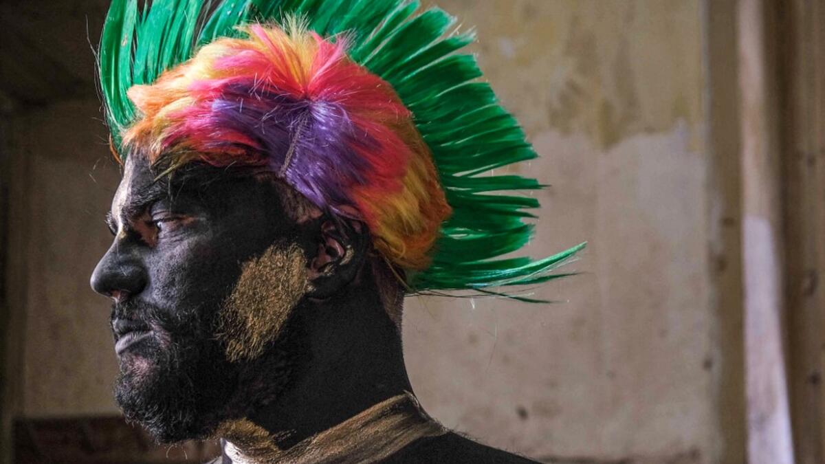 A carnival participant dressed in costume and wearing body paint
