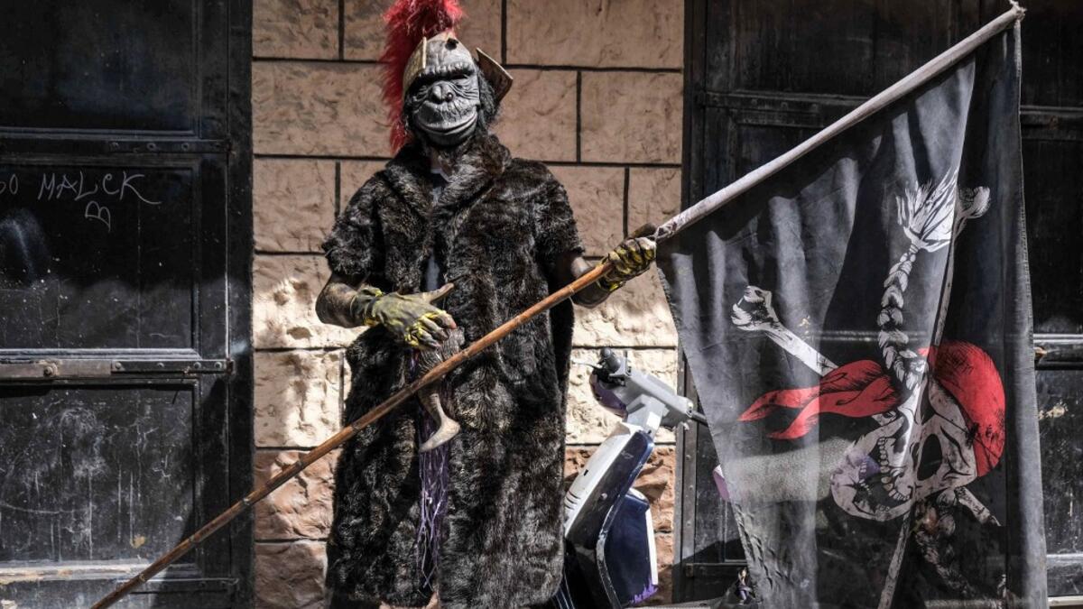 A carnival participant dressed in costume poses for a picture