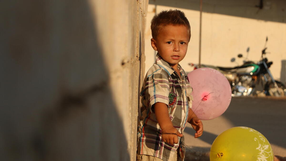 On 28 August 2018 in Idlib, Syrian Arab Republic, Ali, 3, stands near his temporary shelter. Ali was displaced with his family from northern rural Hama to Atma collective shelter near the Syrian-Turkish boarders.