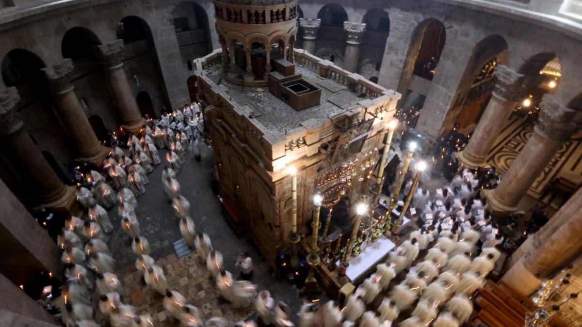 Christian worshippers, monks, and friars walk in procession around the Edicule, traditionally believed to be the burial site of Jesus Christ