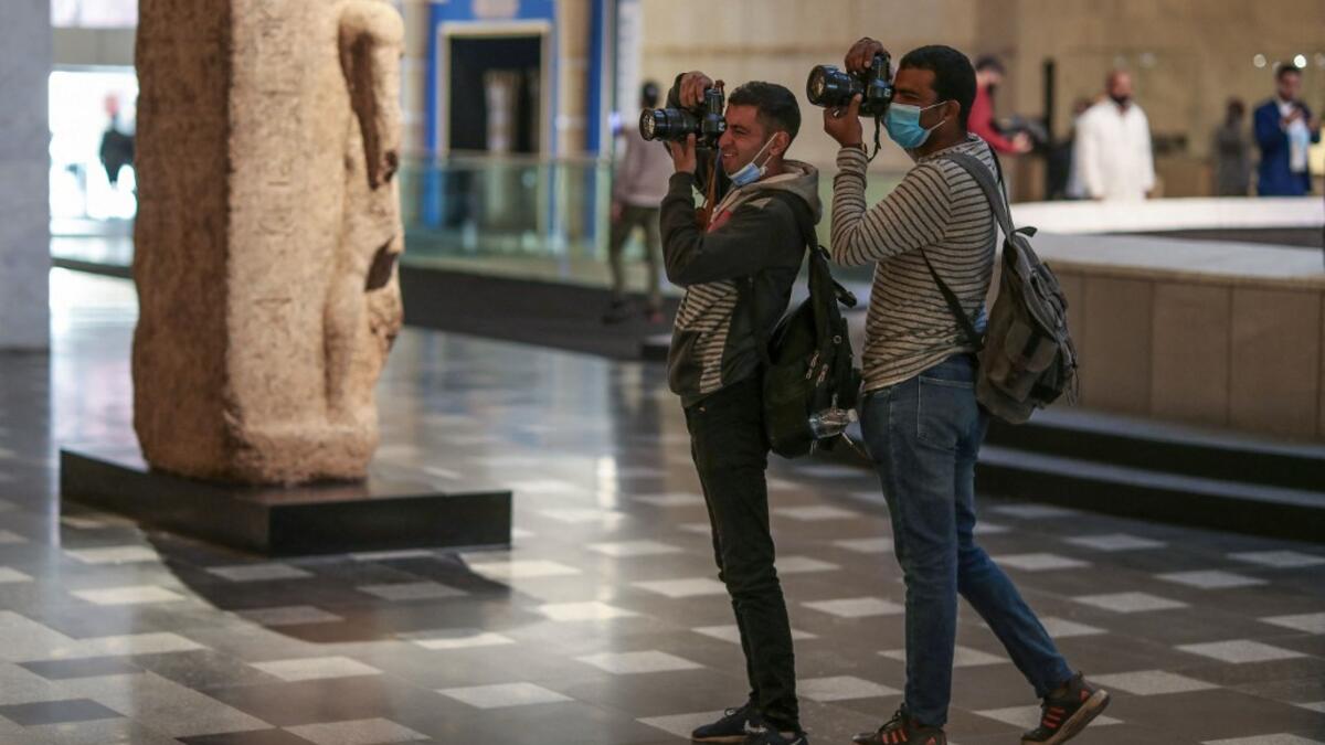 Photojournalists take pictures at Egypt's new National Museum of Egyptian Civilisation