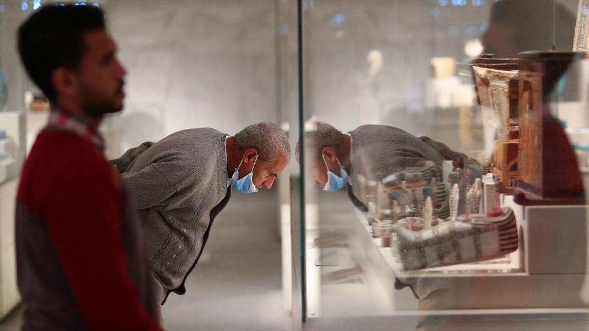 People look at displayed artifacts at Egypt's new National Museum of Egyptian Civilisation (NMEC)