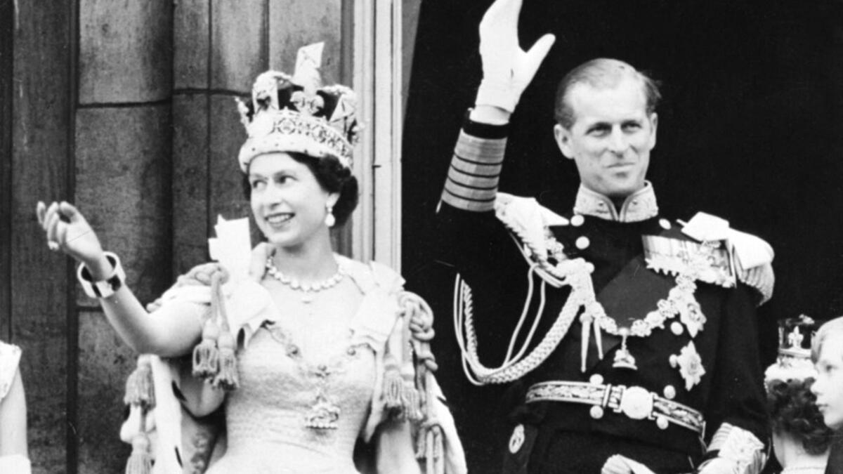 June 2, 1953 Britain's Queen Elizabeth II (L) accompanied by Britain's Prince Philip, Duke of Edinburgh (R) waves to the crowd, June 2, 1953