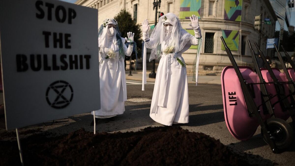 WASHINGTON, DC - APRIL 22: Activists halt traffic and dump a pile of manure outside the White House while protesting against President Joe Biden's climate change policy on Earth Day