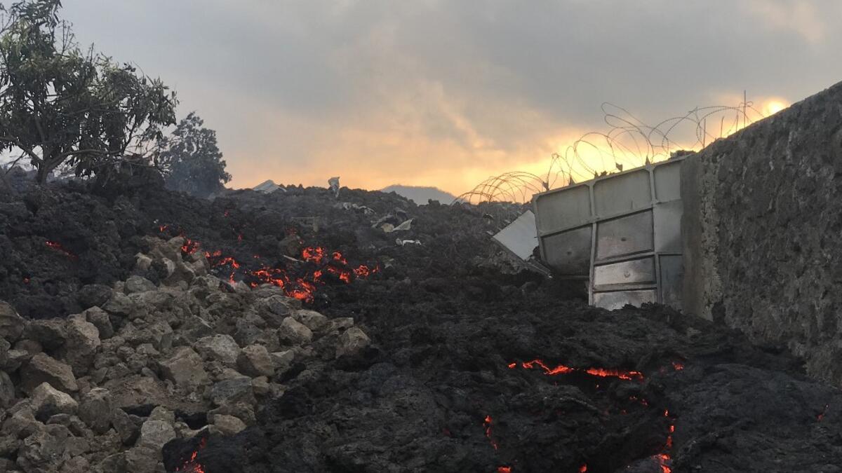 Smoldering ashes are seen early morning in Goma in the East of the Democratic Republic of Congo on May 23, 2021 following the eruption of Mount Nyiragongo. Thousands have fled a volcanic eruption in the Democratic Republic of Congo with lava from Mount Nyiragongo reaching Goma city early Sunday. Even before the official announcement, people had started filling the streets and carrying what they could as they headed out of the city, where the last major eruption killed 100 people