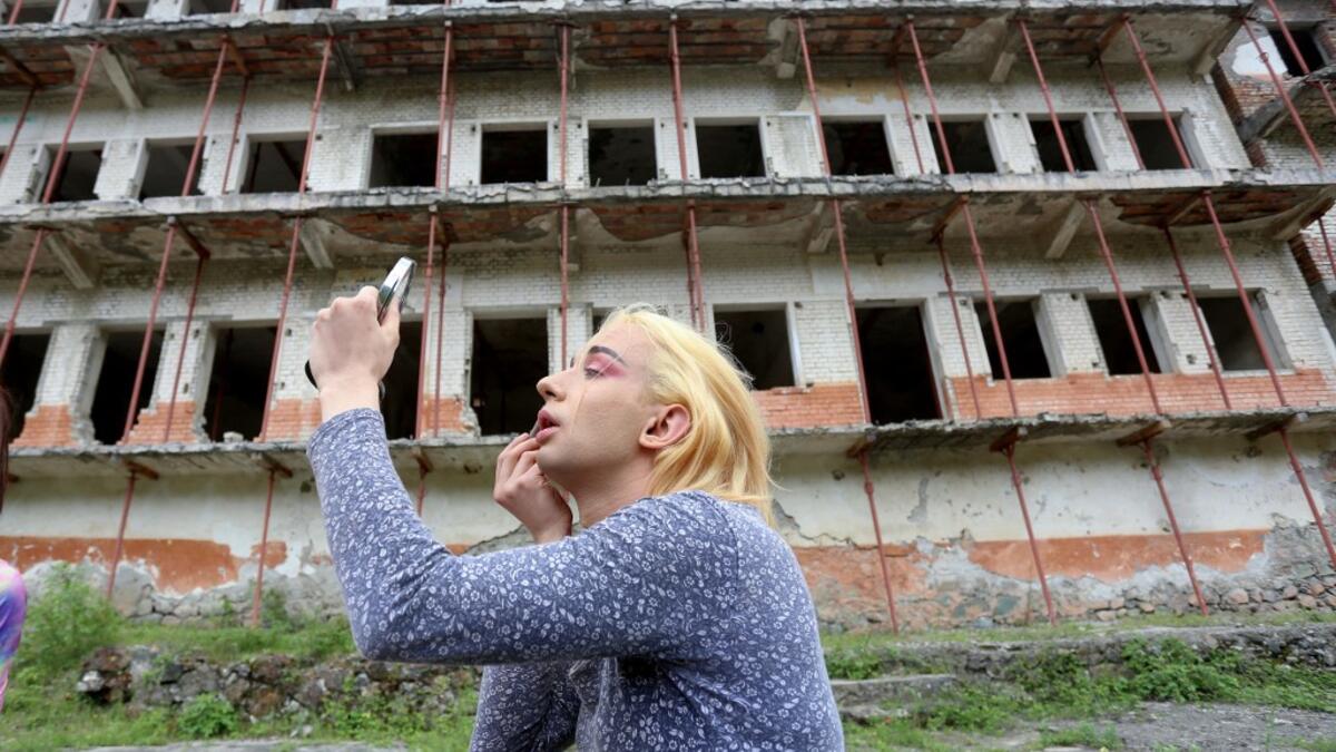 Albanian transgender Lola, puts her makeup on, in the former Communist-era maximum security prison for political prisoners in Spac