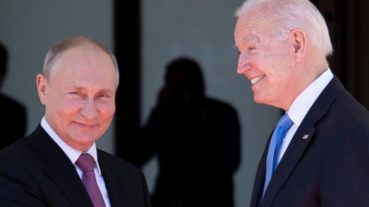 Russian President Vladimir Putin (L) shakes hands with US President Joe Biden prior to the US-Russia summit at the Villa La Grange, in Geneva