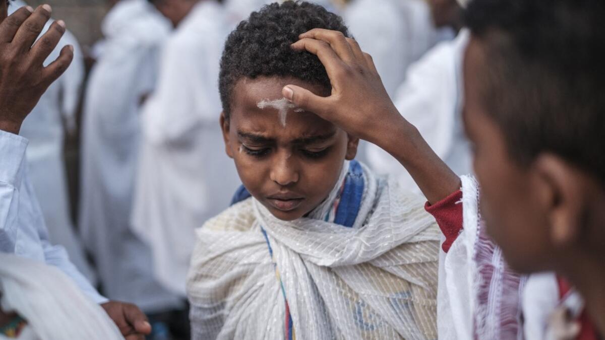 An Ethiopian Orthodox child gets a cross drawn in his forehead with ashes during the religious celebration of Saint Michael in the city of Bahir Dar, Ethiopia