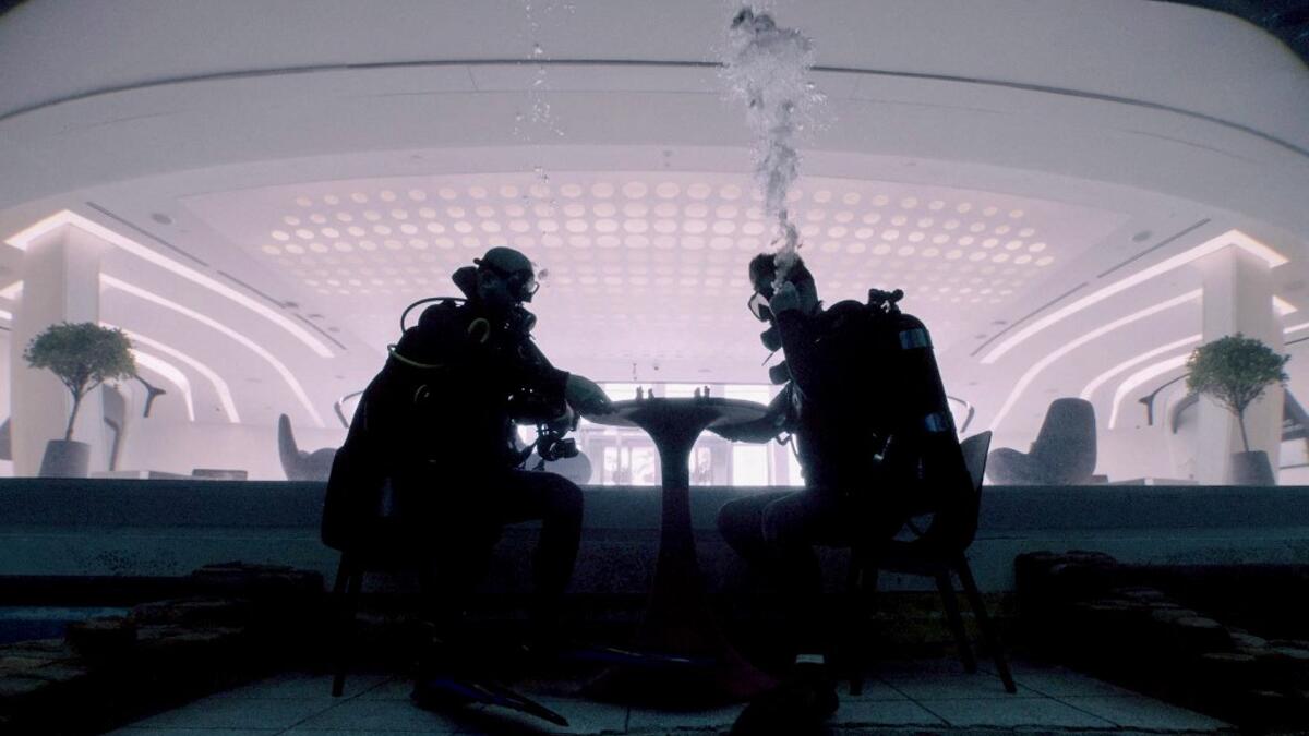 Divers play mock chess while experiencing Deep Dive Dubai, the deepest swimming pool in the world reaching 60m, in the United Arab Emirates, on July 10, 2021. The city of superlatives, with the world's tallest tower among its many records, Dubai now has the deepest swimming pool on the planet complete with a "sunken city" for divers to explore. GIUSEPPE CACACE / AFP