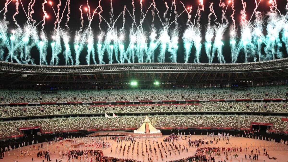 Fireworks go off around the Olympic Stadium after the lighting of the Olympic Flame during the opening ceremony of the Tokyo 2020 Olympic Games