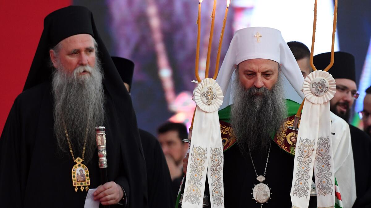 Serbian Orthodox Church's patriarch Porfirije (R) and bishop Joanikije (L) walk through the crowd gathered in front of the orthodox cathedral in Podgorica, on September 4, 2021, to celebrate and show support for the enthronement of the new bishop of the Serbian Orthodox Church in Montenegro. autocephaly.