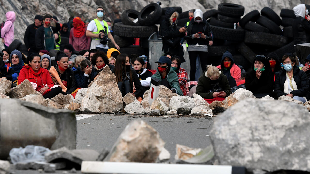 Demonstrators gather at a barricade set up to block access roads to the historic city of Cetinje during a protest against the inauguration of the new head of the Serbian Orthodox Church on September 5, 2021 in Montenegro. The new head of the Serbian Orthodox Church in Montenegro was inaugurated, arriving by helicopter under the protection of police who dispersed protesters with tear gas.