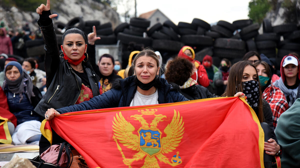 Demonstrators gather at a barricade set up to block access roads to the historic city of Cetinje during a protest against the inauguration of the new head of the Serbian Orthodox Church on September 5, 2021 in Montenegro.