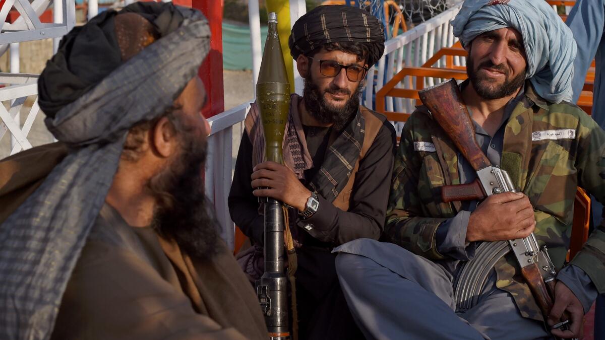 "This is Afghanistan!" a Taliban fighter shouts on the pirate ship ride at a fairground in western Kabul, as his armed comrades cackle and whoop on board the rickety attraction. (Photo by WAKIL KOHSAR / AFP) / TO GO WITH: AFGHANISTAN-CONFLICT-FAIRGROUND, SCENE BY JAMES EDGAR - TO GO WITH: Afghanistan-conflict-fairground, SCENE by James EDGAR