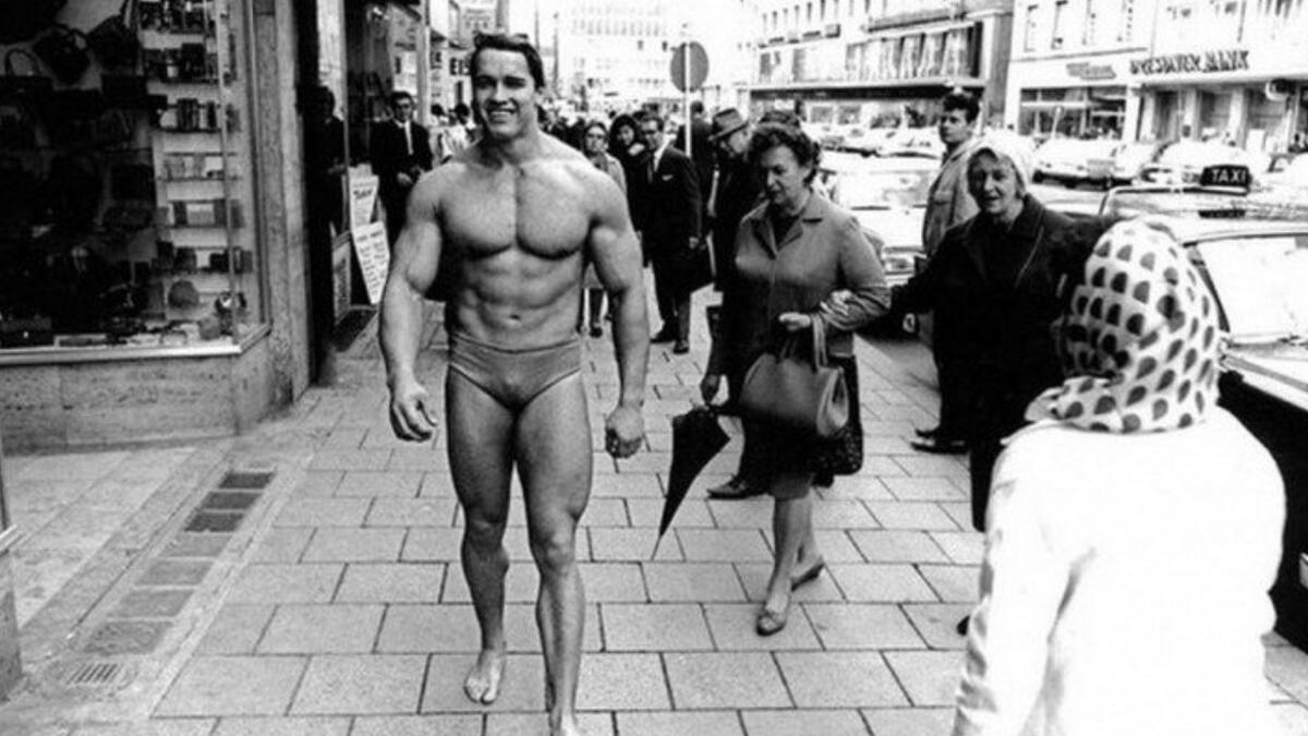 Arnold Schwarzenegger promoting his own gym in Munich wearing nothing but swim trunks November, 1967.