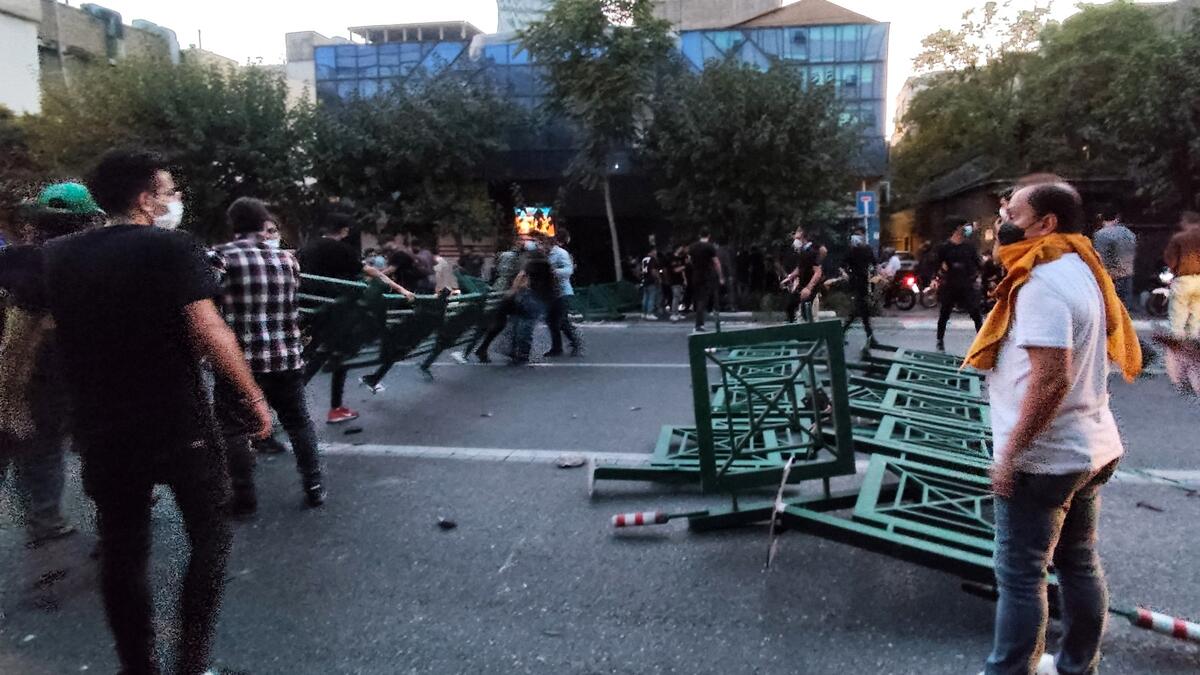 A picture obtained by AFP outside Iran on September 21, 2022, shows Iranian demonstrators taking to the streets of the capital Tehran during a protest for Mahsa Amini, days after she died in police custody. (Photo by AFP) Mahsa Amini