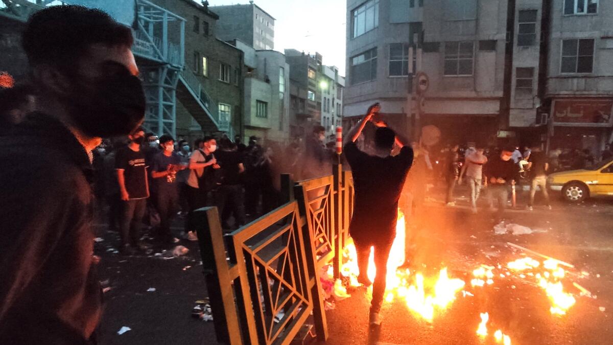 A picture obtained by AFP outside Iran on September 21, 2022, shows Iranian demonstrators taking to the streets of the capital Tehran during a protest for Mahsa Amini, days after she died in police custody. (Photo by AFP) Mahsa Amini