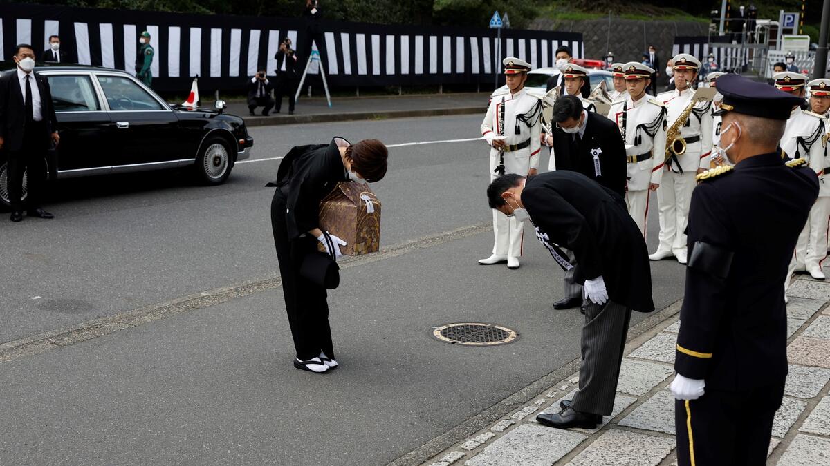 Akie Abe (L), wife of Japan's former prime minister Shinzo Abe, bows to Japan's current Prime Minister Fumio Kishida (2nd R) as she carries a cinerary urn containing her husband's ashes as she arrives to attend his state funeral at the Nippon Budokan in Tokyo on September 27, 2022. (Photo by Kiyoshi Ota / POOL / AFP) Shinzo Abe