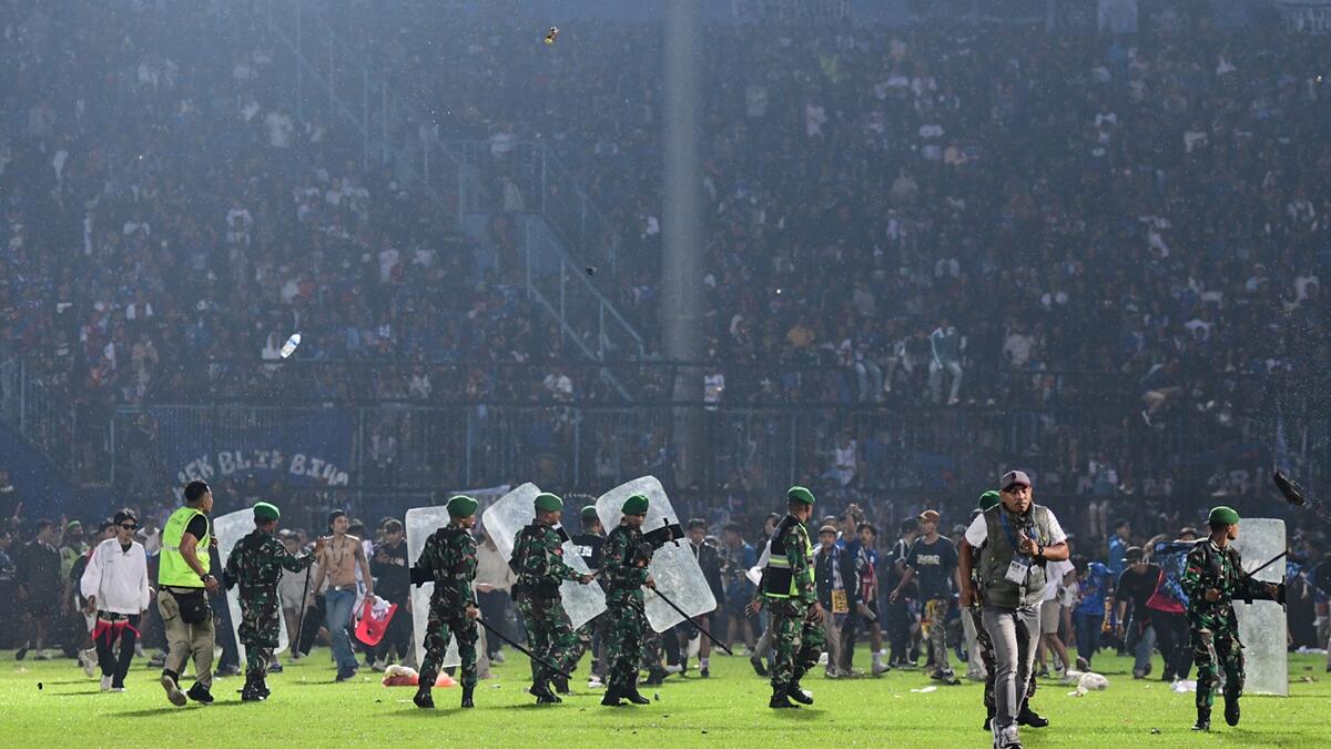 At least 127 people died at a football stadium in Indonesia late on October 1 when fans invaded the pitch and police responded with tear gas, triggering a stampede, officials said. (Photo by AFP) Indonesia's football stadium