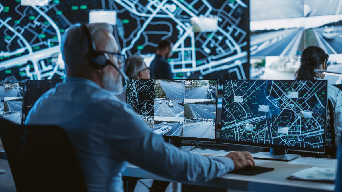 Technical Customer Support Specialist is Talking on a Headset while Working on a Computer in a Call Center Control Room Filled Display Screens with Monitoring Software. Over the Shoulder Footage (Shutterstock ) Technical Customer Support Specialist is Talking on a Headset while Working on a Computer in a Call Center Control Room Filled Display Screens with Monitoring Software. Over the Shoulder Footage