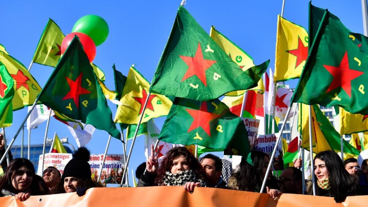 Protesters hold flags of the mainly-Kurdish militia in Syria, the People's Protection Units (YPG, yellow flags), and of its female equivalent, the Women's Protection Units (YPJ, green flags). 
(John MACDOUGALL / AFP)