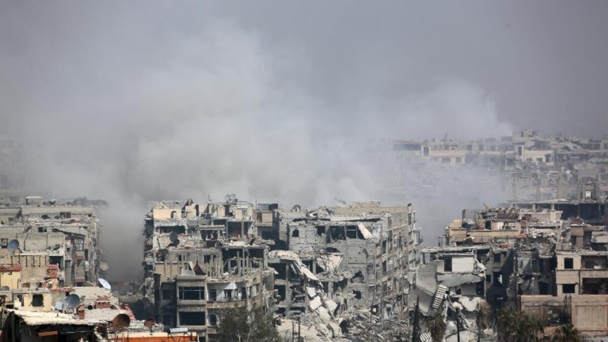 Smoke billows following Syrian government bombardment on the rebel-held besieged town of Harasta, in the Eastern Ghouta region on the outskirts of Damascus on Mar. 12, 2018. (AFP)
