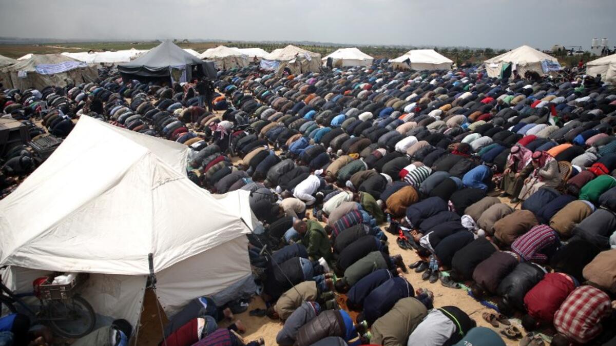 Muslim worshipers perform Friday noon prayers during a tent city protest near the border with Israel east of Jabalia to commemorate Land Day on Mar. 30, 2018. Land Day marks the killing of six Arab Israelis during 1976 demonstrations against Israeli confiscations of Arab land.
(Mohammed ABED / AFP)