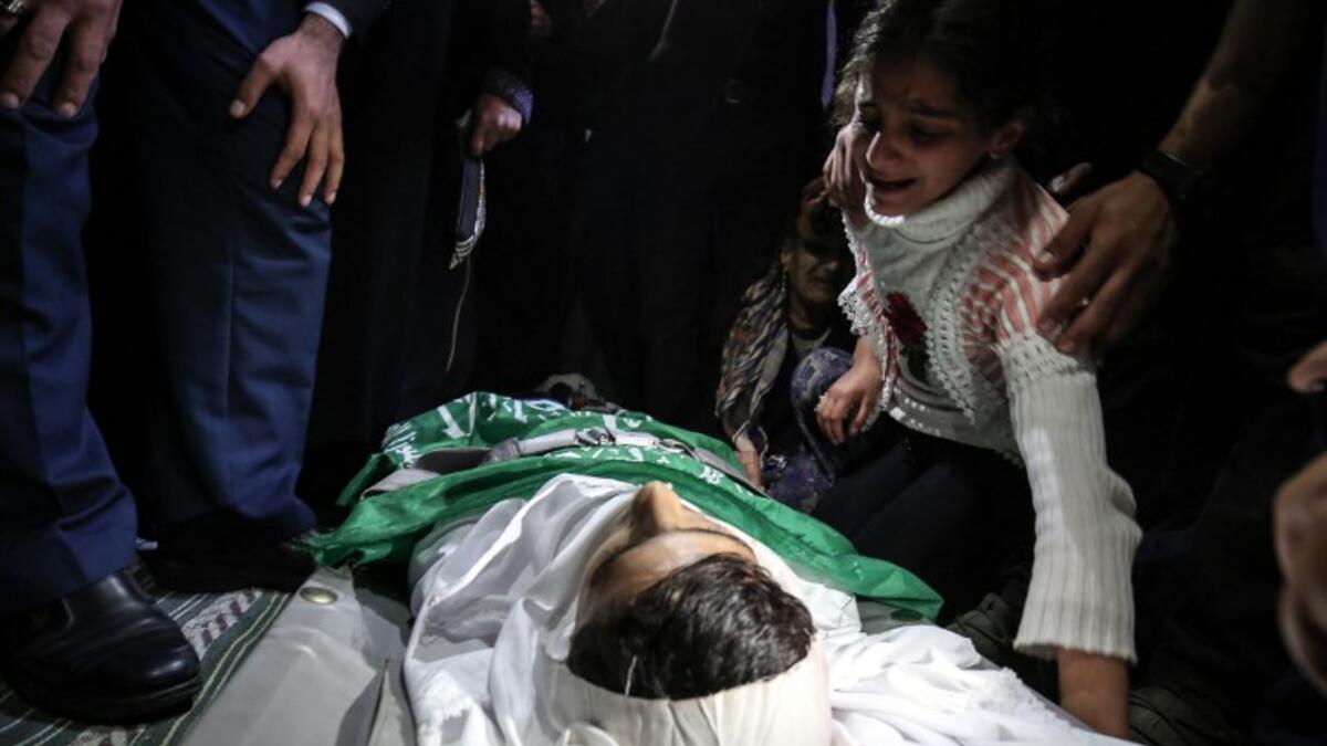 Relatives mourn over the body of Alaa al-Zamili, a teenager who died the day before from wounds sustained in clashes with Israeli forces on the border with Israel, during his funeral on Apr. 7, 2018, in the southern Gaza Strip town of Rafah. 
(SAID KHATIB / AFP)