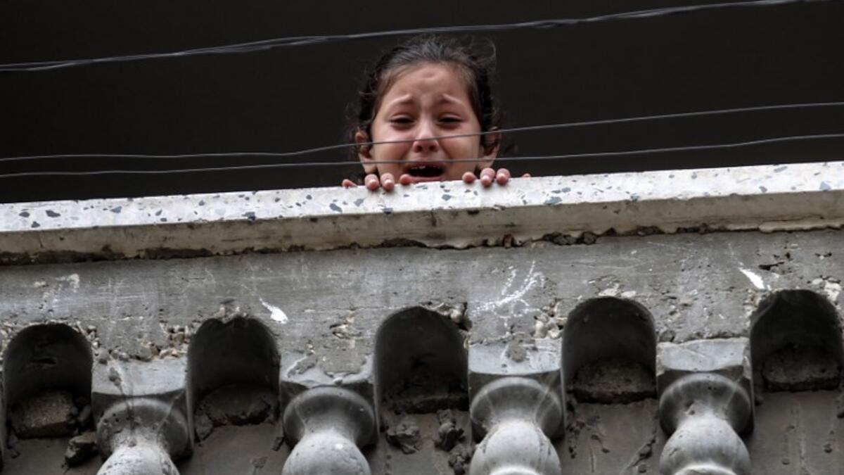 A relative of 29-year-old Saadi Abu Taha, who was killed at the Israel-Gaza border during protests, mourns while looking out of a balcony in Khan Yunis in the southern Gaza strip on Apr. 21, 2018.
SAID KHATIB / AFP