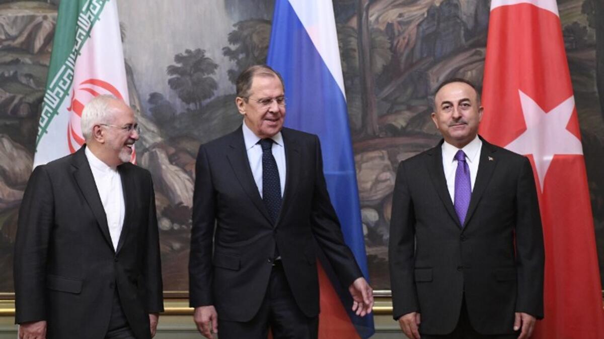 Russian Foreign Minister Sergei Lavrov (C), his Turkish counterpart Mevlut Cavusoglu (R) and Iran's Foreign Minister Mohammad Javad Zarif pose for pictures prior to their meeting in Moscow on April 28, 2018. Alexander NEMENOV / AFP