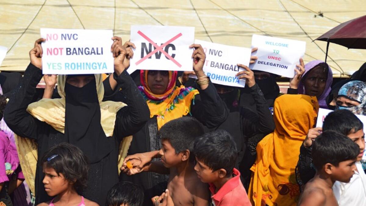 Rohingya refugees women hold placards to members of United nations Security Council team during their visit to Kutupalong refugee camp in Bangladesh's Ukhia's district on 29 April 2018.  Sam Jahan/AFP